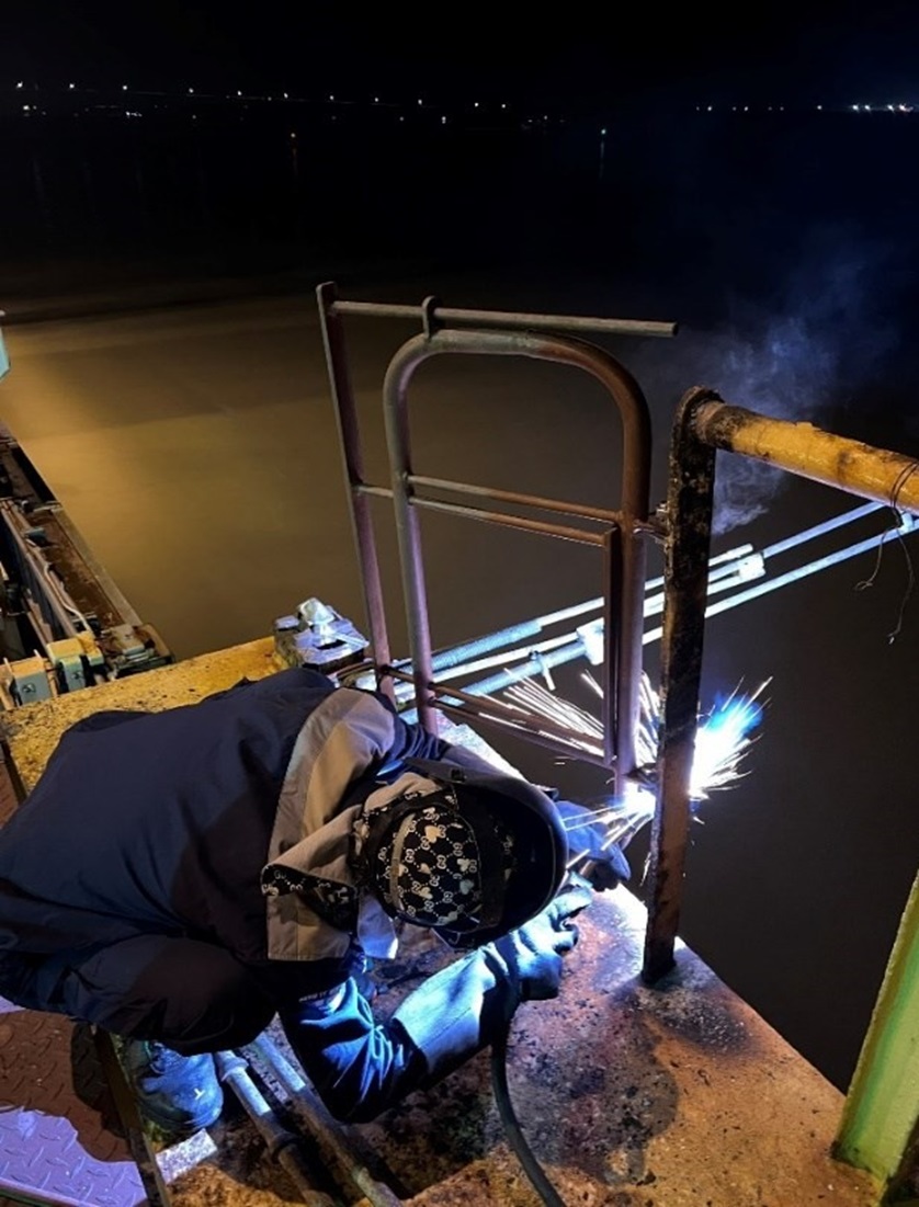 repair on deck in ship at hai phong port, viet nam.